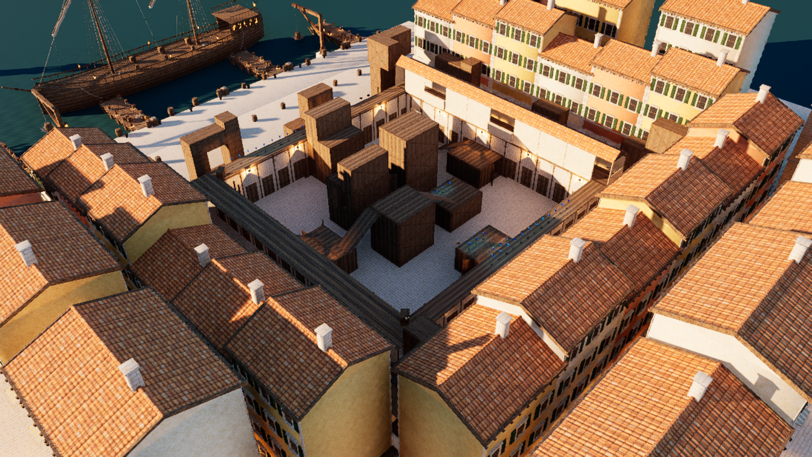 Shipment 1519 Big from an elevated development camera: the cargo courtyard sits inside galleries and waterfront buildings, with the galley beyond the arena boundary.